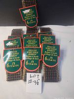 Ten packaged rolls of plaid wire edge ribbon