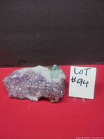 Front view showing purple crystal face and size reference card