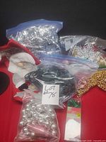 Multiple bags of ornaments, garland, stocking, loose light string