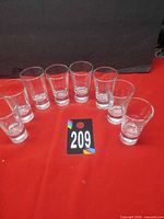 Set of eight tall slim clear shot glasses arranged in row
