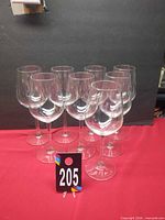 Eight matching wine glasses arranged in two rows