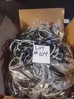 Box filled with multiple silver and black glitter chain garlands