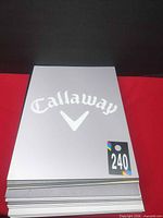 Stack of signs showing Callaway logo on top panel