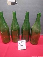 Group shot of four green bottles front view