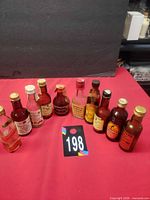 Group shot of all ten empty mini liquor bottles with labels and caps visible