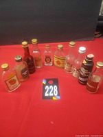 All ten vintage mini liquor bottles arranged on red surface