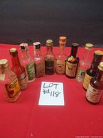 Front view of all 10 bottles lined up on red surface