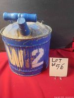 front view showing ribbed body, spout, paint wear, stencilled number