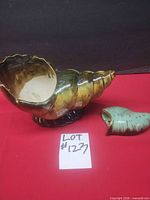 Large glazed ceramic conch planter and smaller shell dish together