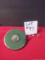 Front view of tape measure showing knob and overall appearance