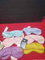 Six assorted satin sleep masks displayed