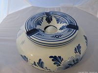 Top view showing lid with four cigarette rests and blue floral design