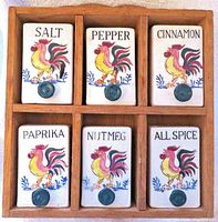 Front view of rack with six rooster-decorated ceramic drawers