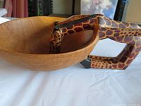 Overall view of wooden bowl with giraffe handles