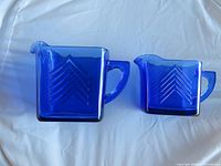 Front view of both cobalt blue Hazel Atlas pitchers