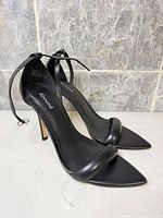 Side view of both sandals showing ankle straps, pointed toes and stiletto heels