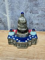 Front view showing Capitol shape, dome, patriotic roof, clasp