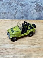 Left front quarter view showing body color, decals, wheels and bumper