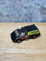 Left side and front three-quarter view showing body color, graphics and wheels