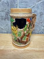 Front view showing hunter, dog, stag relief