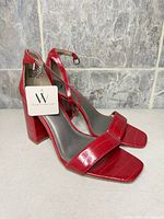 Full side view of both sandals with tag attached