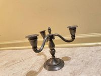 Front view of pewter-tone 3-arm candelabra