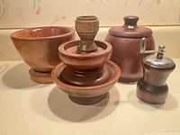 Front view showing pepper mill, lidded jar, stacked bowls