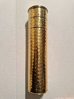 Full view of hammered brass match canister