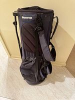 Full view of Burton golf stand bag showing navy fabric, stand legs, pockets