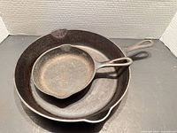 Top view of both skillets nested showing interiors, handles and pour spouts