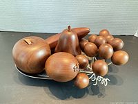 Full set of wooden fruit displayed on metal tray