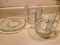 Lot overview showing four soup bowls stacked in pairs beside two sandwich plates