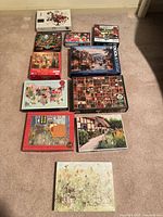 All 11 puzzle boxes laid out on carpet