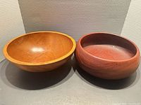 Both wooden bowls side by side, showing relative shapes and finishes