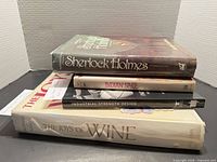 Stack of four books showing spines and thickness