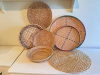 All six woven baskets displayed together on surface