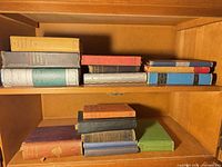 Shelf showing all stacked vintage books