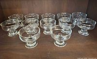 All 12 clear glass footed coupes displayed upright