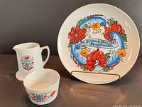 Front view of plate, pitcher and bowl showing pattern and overall condition