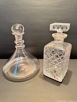 Both decanters side by side showing overall forms and stoppers in place