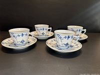 Four teacups each on matching saucer displayed