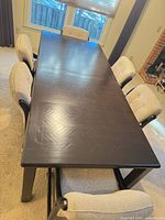 Top view of table with six chairs showing overall style, finish, chair upholstery