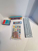 All items grouped: dominoes, cribbage board, two card decks, Lotería set