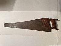 Full view of hand saw showing blade length, handle shape and overall condition
