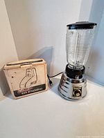 Blender assembled next to boxed icer attachment