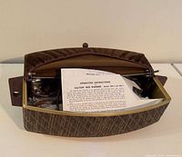 Warmer open with instructions and cord visible