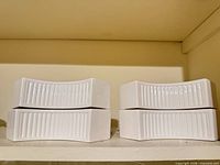 Front view showing four stacked ribbed curved dishes