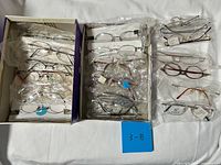 Full view of two boxes containing multiple packaged eyeglass frames