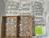 All eyeglasses laid out and boxed, showing quantity and style consistency