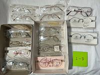 Overall lot showing all eyeglass frames in trays and boxed